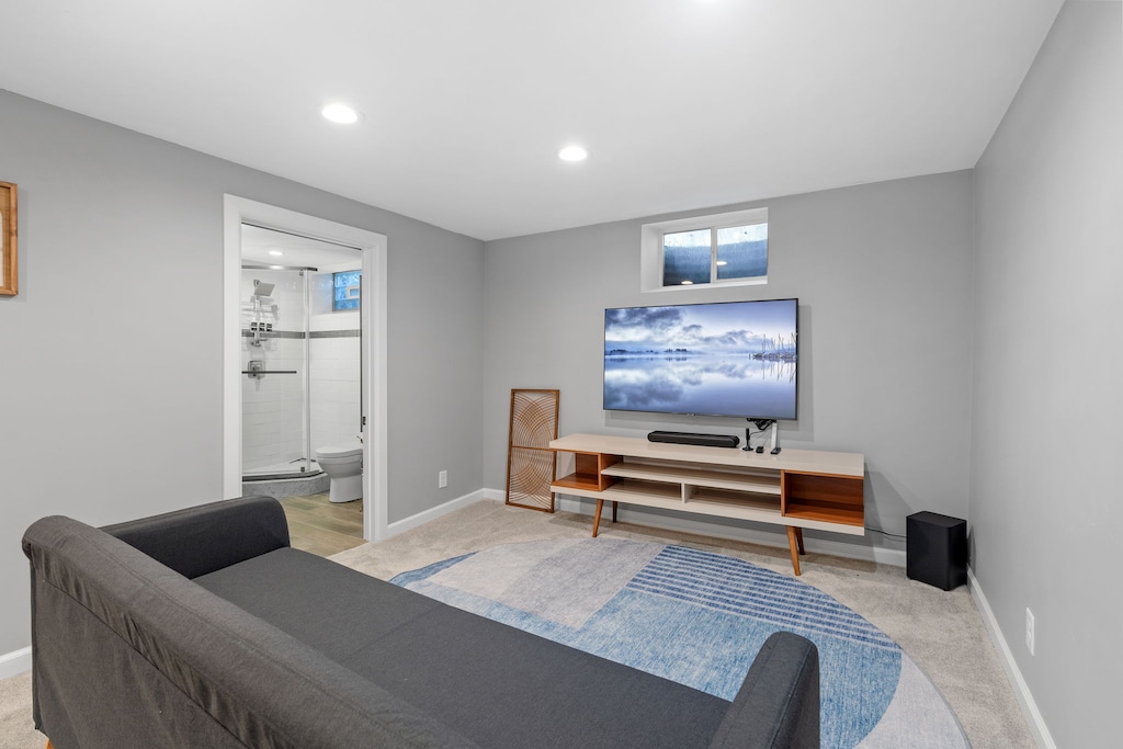 Unwind in your modern living space with sleek entertainment setup and stylish furnishings - perfect for cozy evenings in.