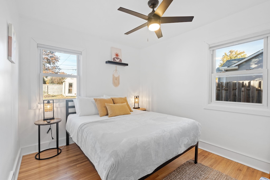 Rest peacefully in your bright bedroom featuring soft linens and warm wood floors.