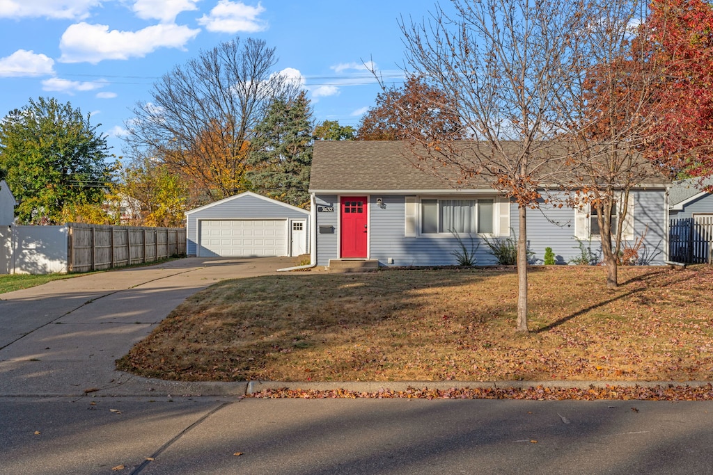 Charming single-story home with vibrant red door welcomes guests in a peaceful residential neighborhood surrounded by beautiful autumn foliage.
