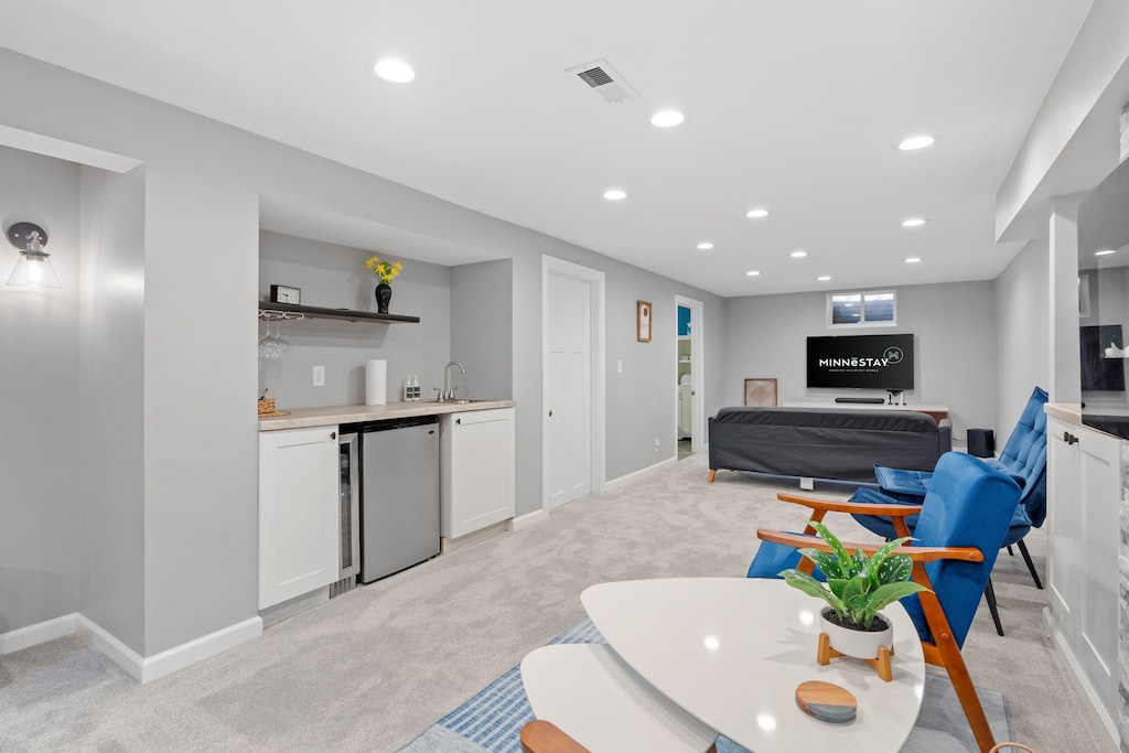 Your stylish basement suite features modern comfort with a full kitchenette, cozy seating area, and entertainment space for relaxing evenings.