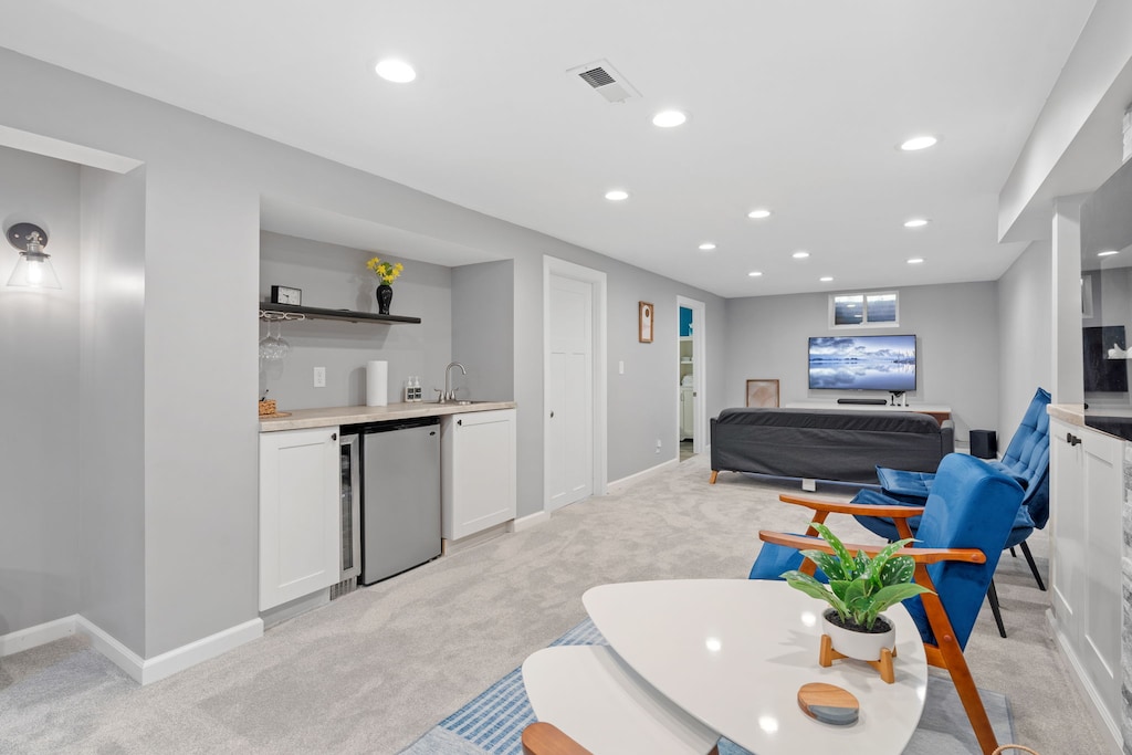 Unwind in your spacious lower-level suite with modern kitchenette, cozy seating, and entertainment center for perfect relaxation.