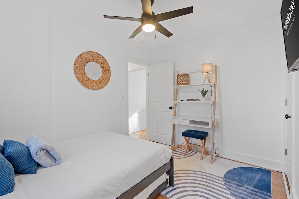 Unwind in your bright, modern bedroom with plush bedding, stylish coastal touches, and a dedicated workspace for ultimate comfort.