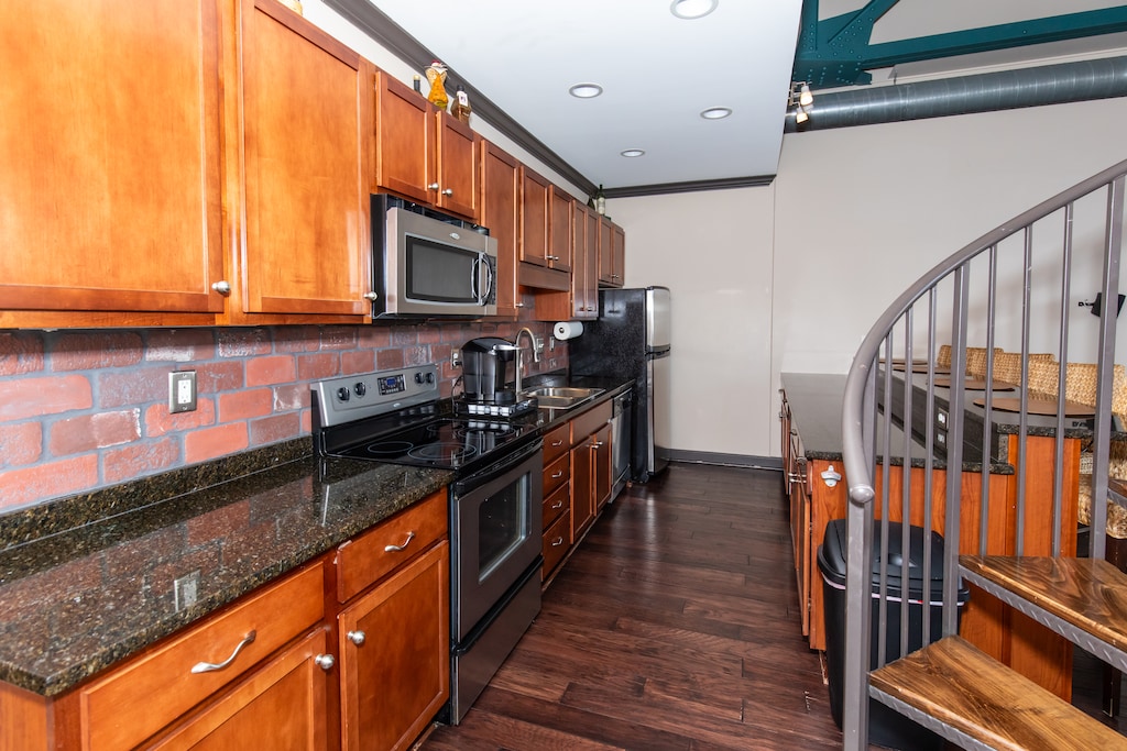 Your fully equipped kitchen features rich wood cabinets, granite counters, and stainless appliances for memorable meals together.