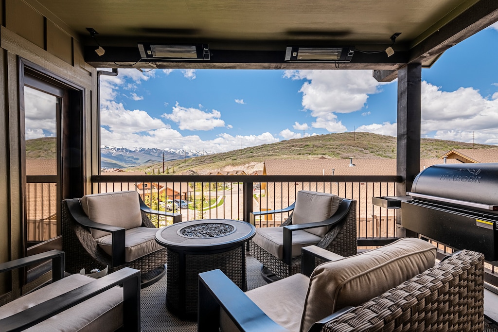 Private deck with fire table and seating, commercial heaters, Traeger BBQ and mountain views