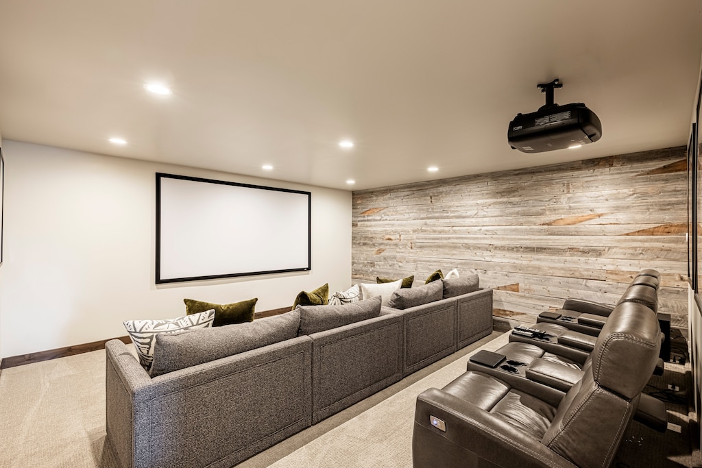 Lower level theater room with sofa and theater chair seating