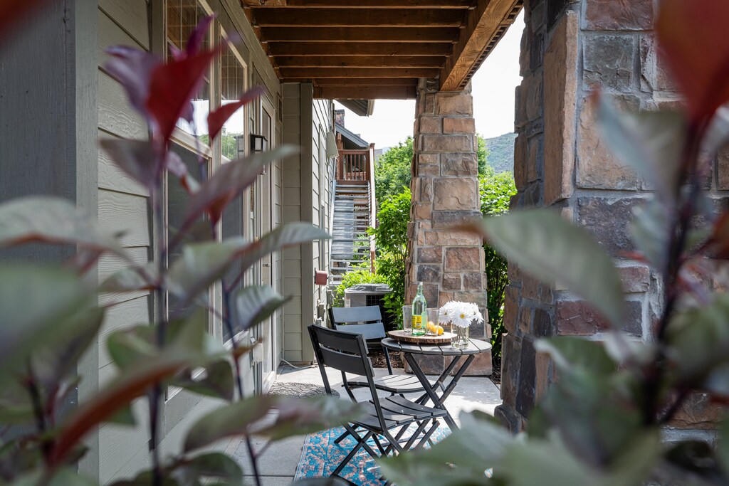 Front porch offers small bistro table and seating for two