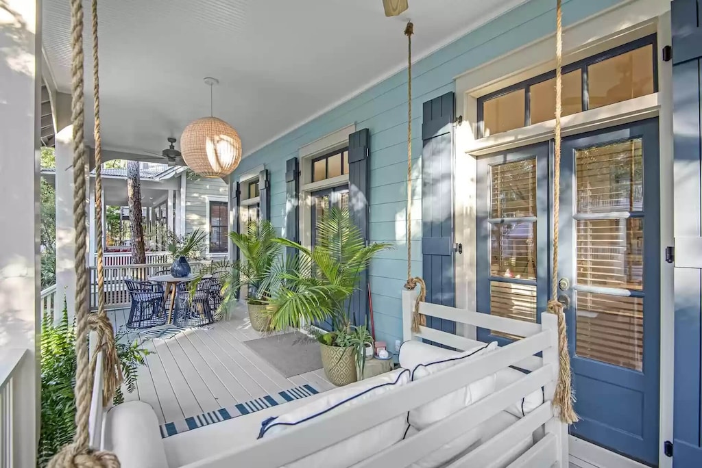 Covered porch with outdoor dining and bench swing