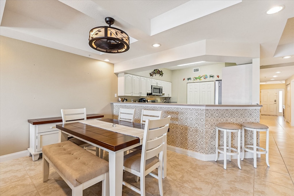 Gather around the charming dining table, sharing laughter and delicious meals under the soft glow of a modern chandelier.