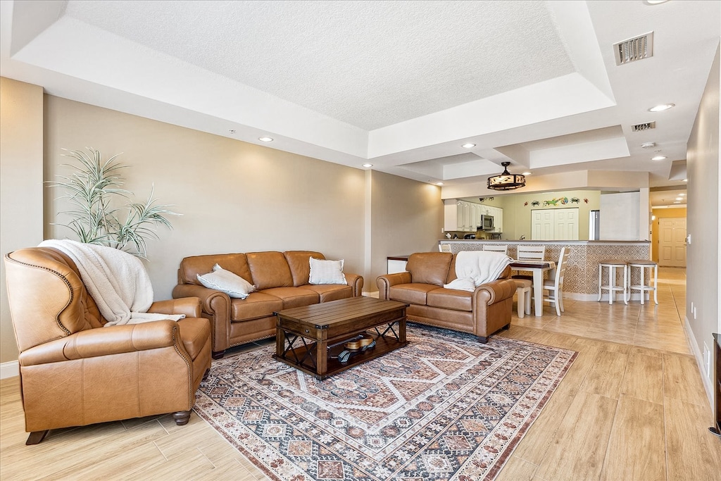 Relax in the spacious living area, where warm lighting, cozy seating, and elegant decor create an inviting atmosphere.