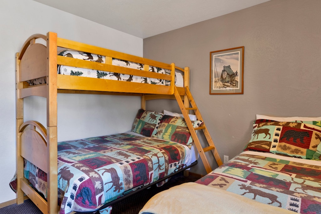 Peaceful cabin bedroom with plush bedding, and beautiful views—ideal for restful nights, cozy mornings, and a relaxing mountain escape.