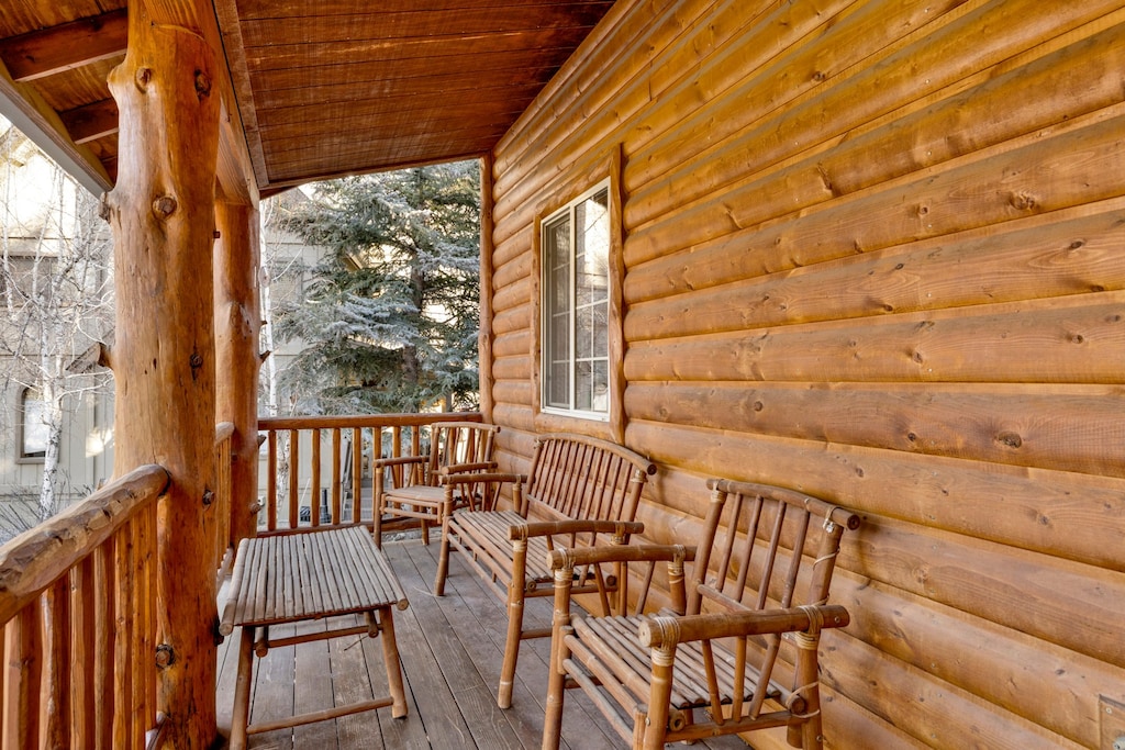 Welcoming cabin entry surrounded by towering pine trees, offering fresh mountain air and a peaceful forest setting—the perfect first impression for your Big Bear Lake getaway.
