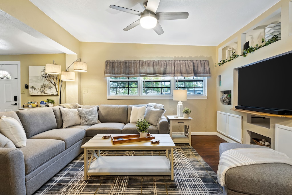 Experience the perfect blend of comfort and entertainment with a plush sofa and a 65" smart TV!