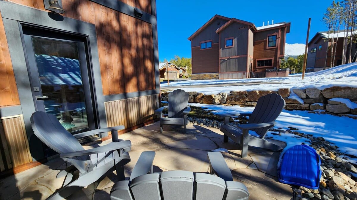 The lower level outdoor space features a small patio space with seating for four and a private hot tub around the corner of the home.