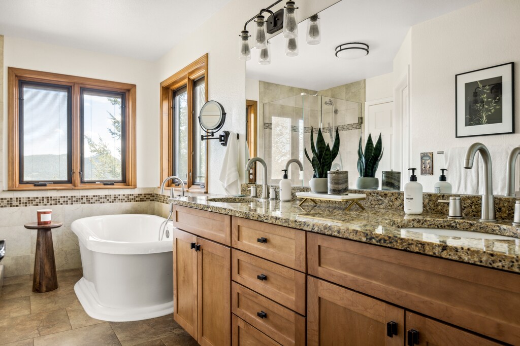 Primary bedroom's private full ensuite bathroom with dual vanities