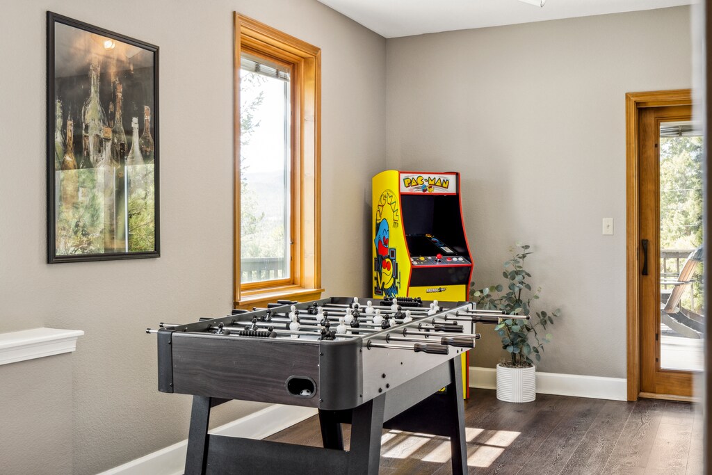 Game room with a foosball table and arcade machine