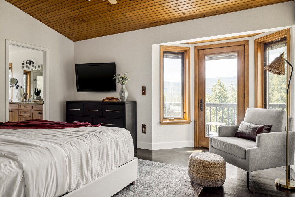 Primary bedroom with a view and private balcony access