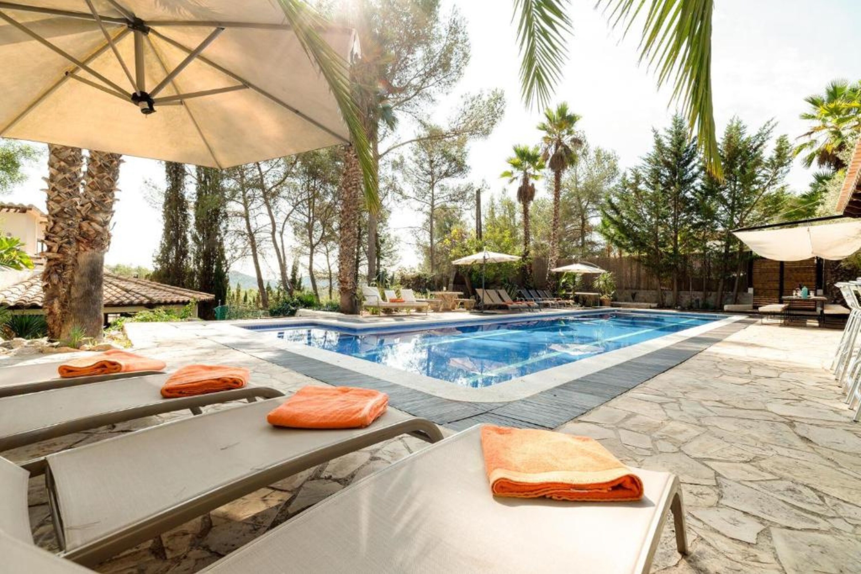 Swimming pool and sun loungers at Sitges Villa Pines.