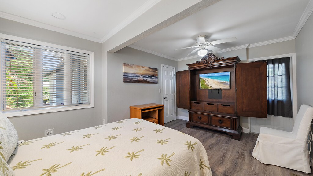 Bedroom with seating Area, Armoire, and Smart TV