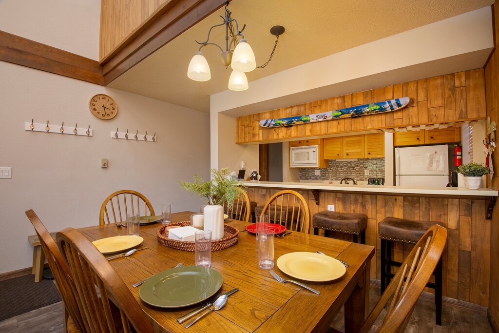 A cozy kitchen and dining area with wooden furniture.