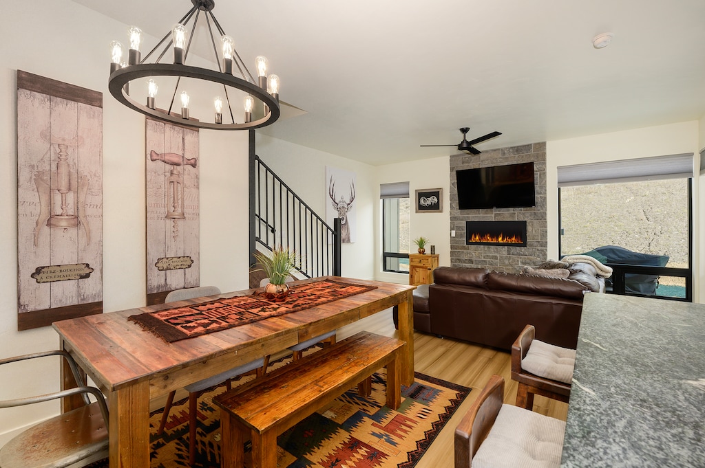 - Rustic dining room with wood table and benches for family gatherings   - Stone fireplace and leather seating add warmth to every shared meal   - Mountain-inspired decor blends style with cozy cabin comfort indoors