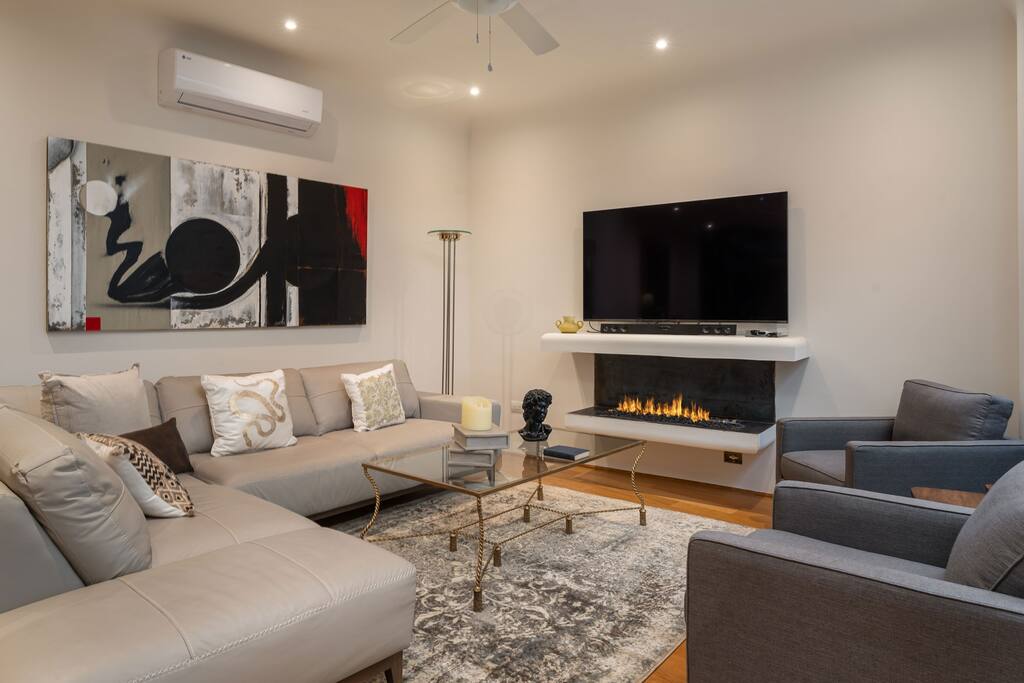 Living room with TV and indoor fireplace