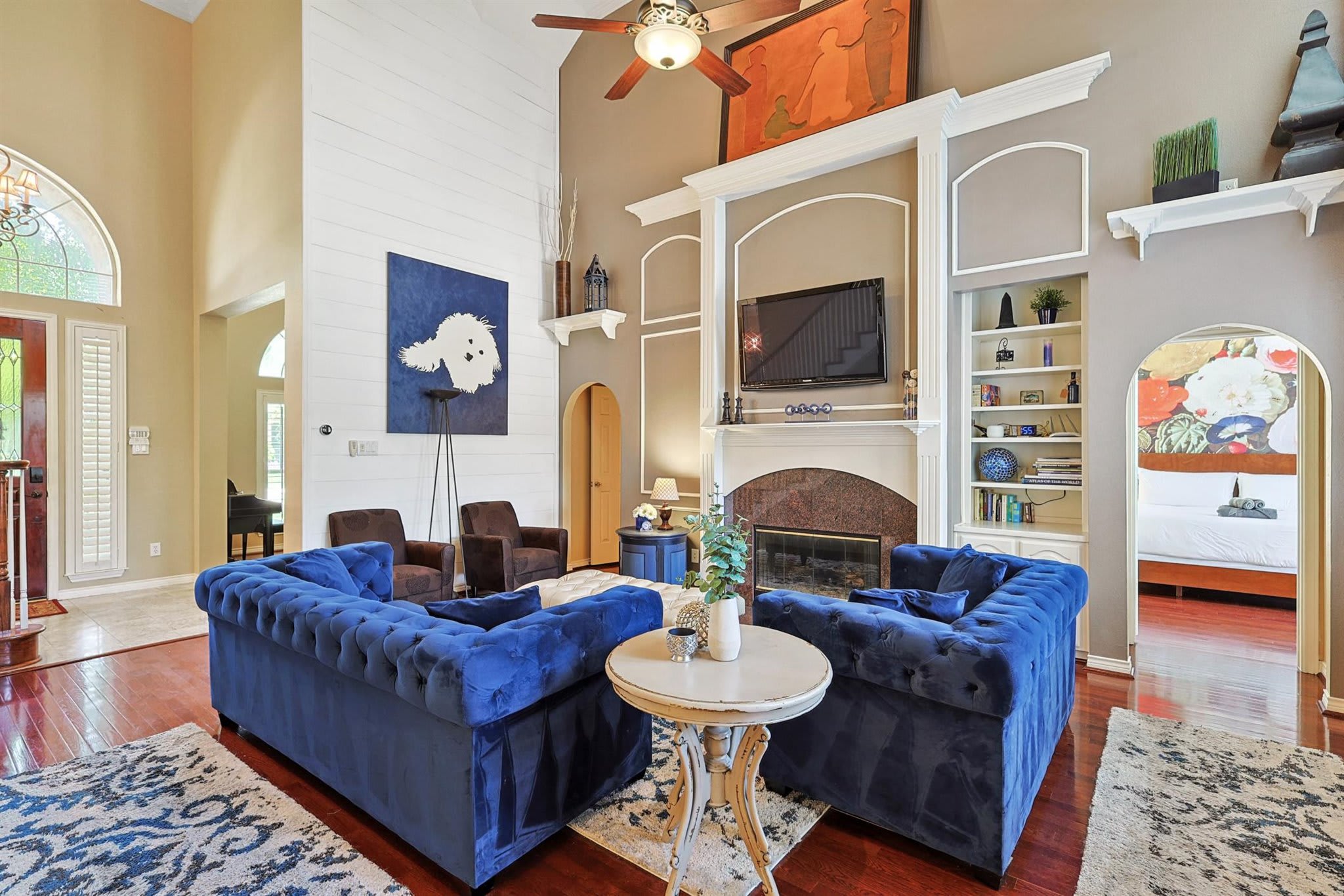 This spacious and sophisticated living room offers plenty of space for everyone to hang out and relax with plenty of seating and high airy ceilings.