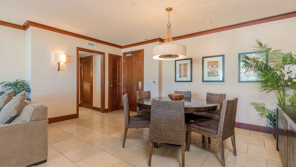 Gather for meals in the elegant dining area with soft lighting and warm decor.