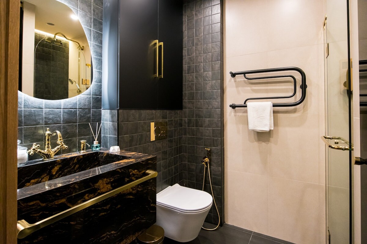 Step into luxury with our spacious bathroom, featuring premium tiles and a retro-style shower set from Germany. The LED mirror adds a touch of elegance, ensuring every moment is an experience in indulgence.