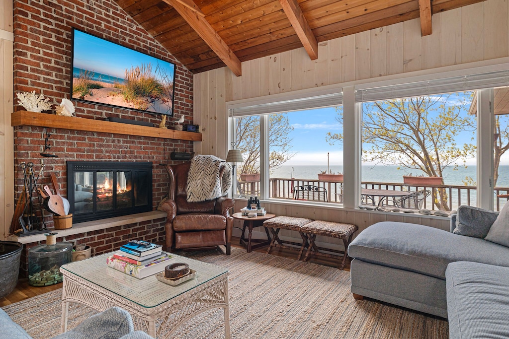 The living room has lots of comfortable seating, a fireplace and flat-screen TV.