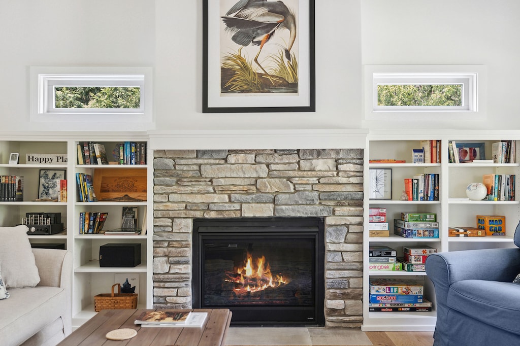 The Cottage has a cozy and inviting living room with stone fireplace.
