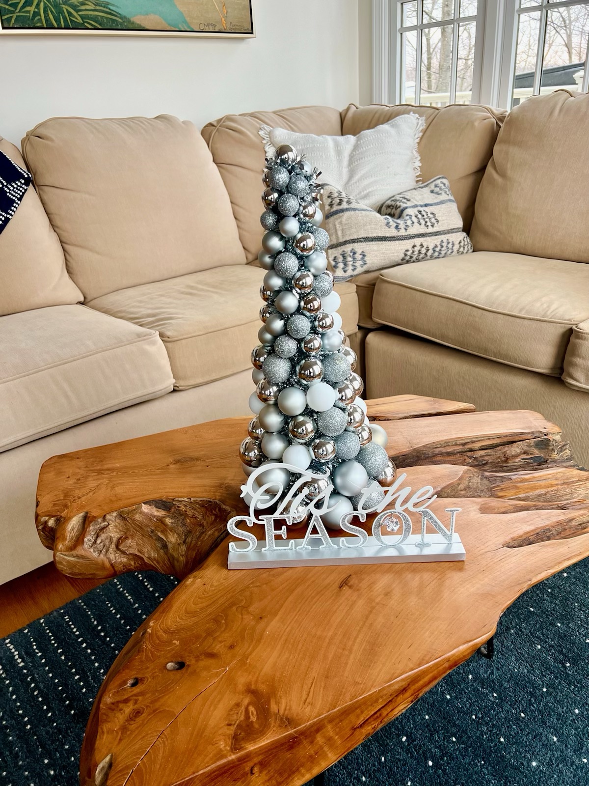 This coffee table, graced by a lovely Christmas tree, captures the essence of the holiday spirit.