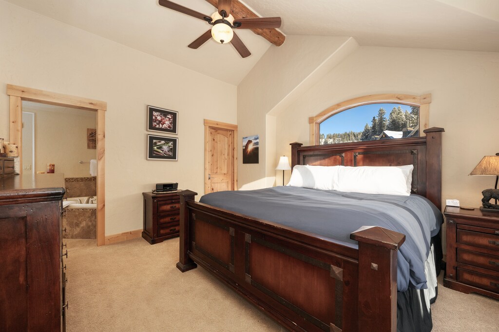 - Spacious bedroom with king bed and mountain window view   - Comfortable alpine retreat with wooden furnishings and charm   - Peaceful sleep space with natural light and cozy comfort