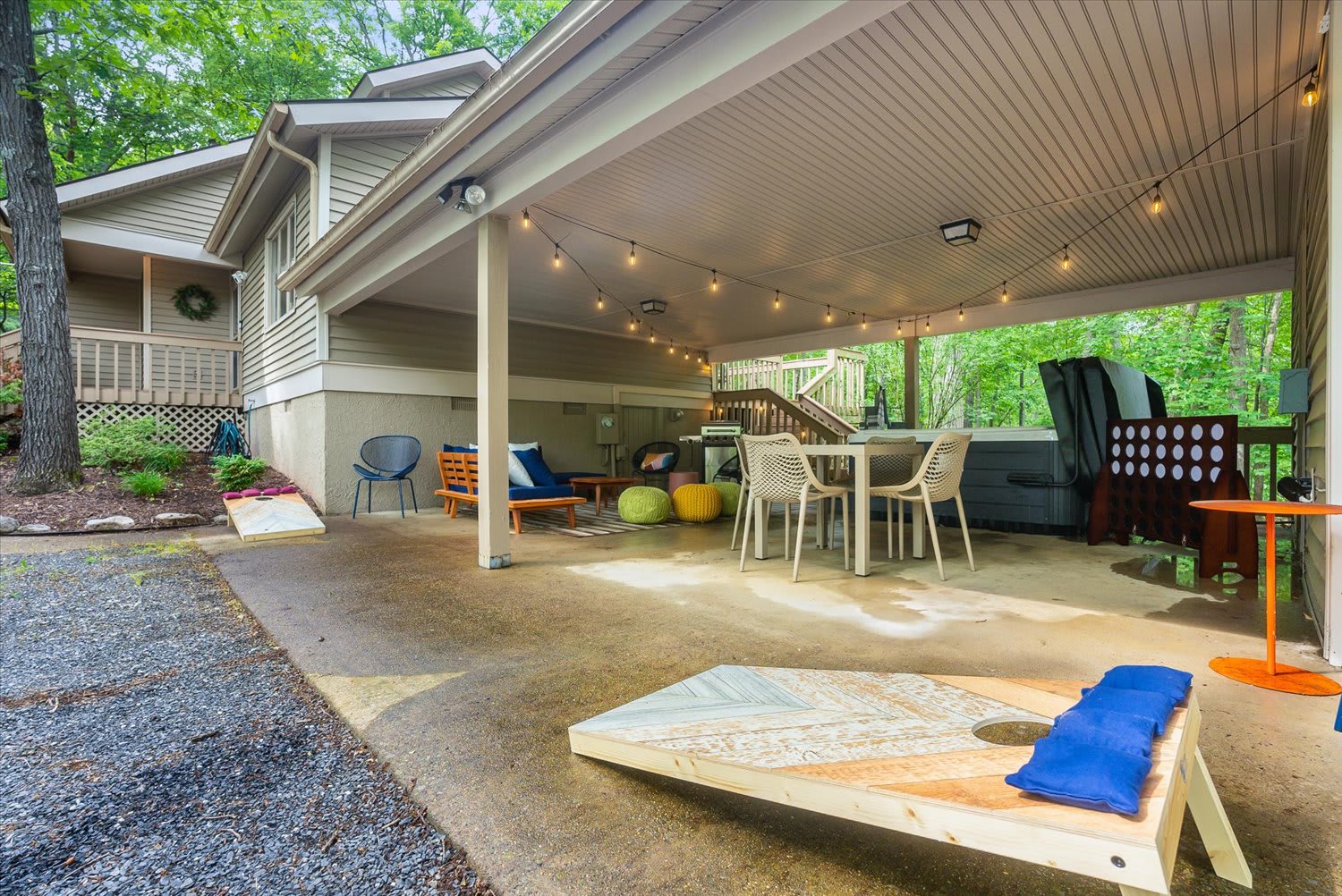 Our carport transforms into a versatile outdoor space with lounging areas, a hot tub, a BBQ grill, and a cornhole for endless fun!