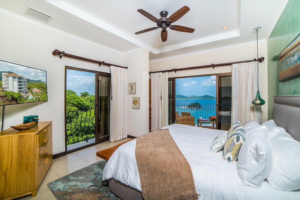 Primary bedroom with direct terrace access and sea views.