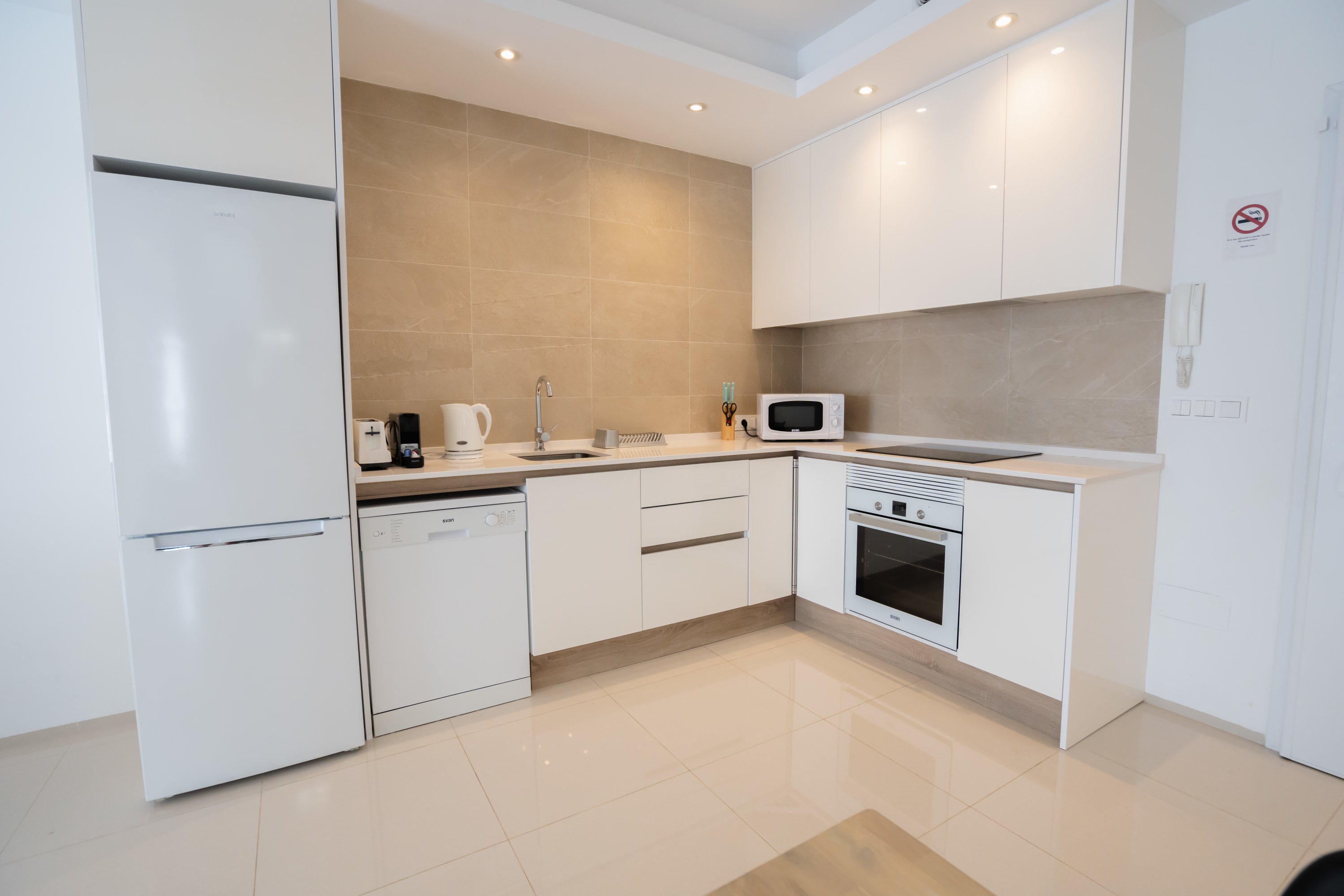 Kitchen with Dining Table, Oven, Stovetop, Microwave, Dishwasher, Fridge and Toaster