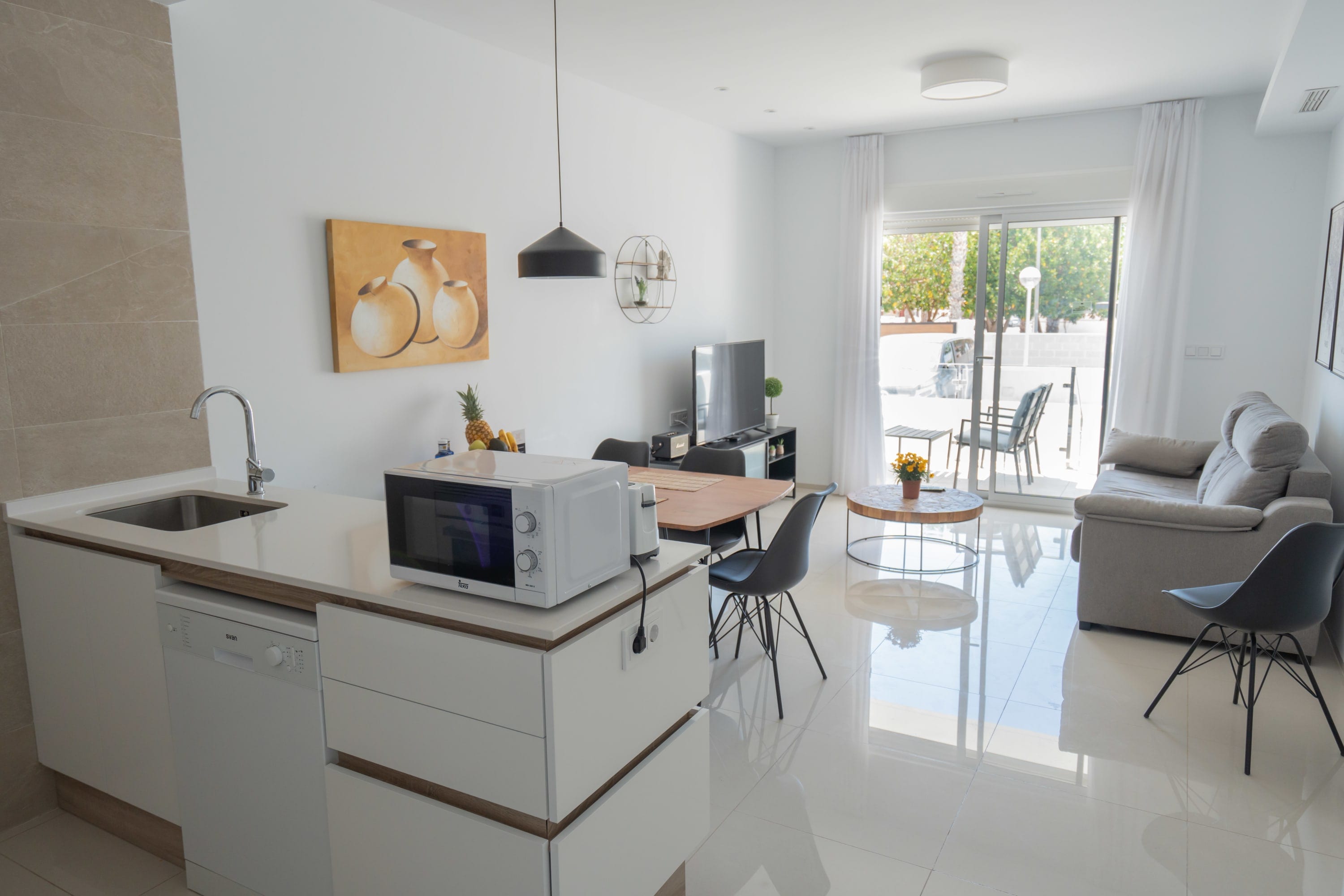 Kitchen with Dining Table, Oven, Stovetop, Microwave, Dishwasher, Fridge and Toaster