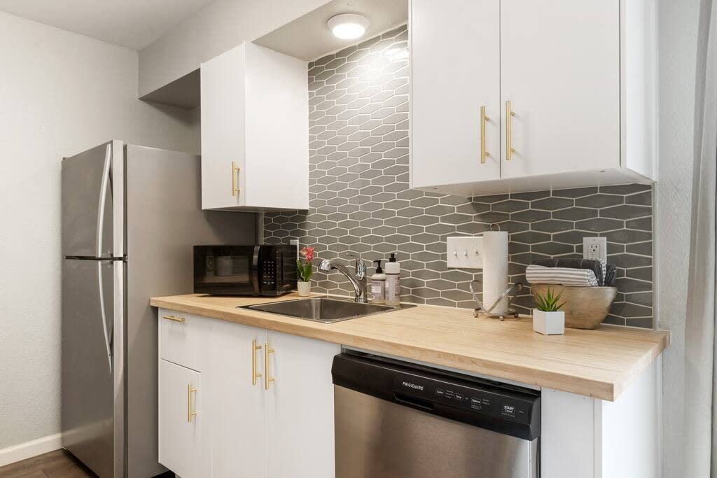 Full kitchen with dishwasher and appliances