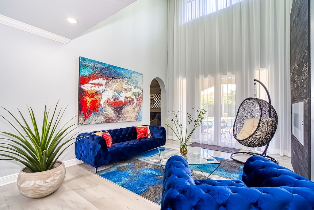 With high ceilings, bright windows, and elegant drapery, this living room has been specially curated to provide you with a place for scintillating conversation.