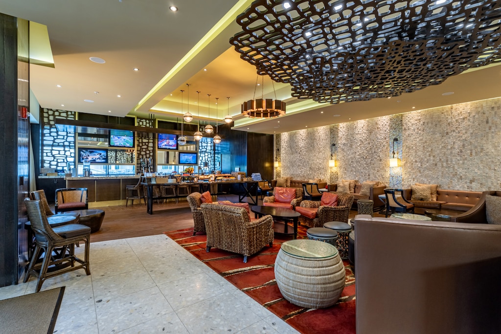 Modern indoor lounge with bar, TVs, and cozy seating to enjoy after a day in the sun.