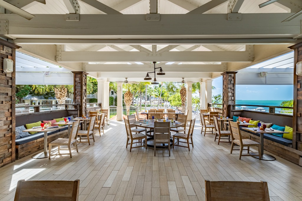 Dine by the sea in an open-air restaurant offering fresh meals with stunning views.