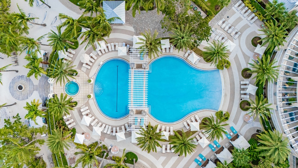 Resort pool with cabanas & palm trees 🌞 — available for all guests (not a private pool).