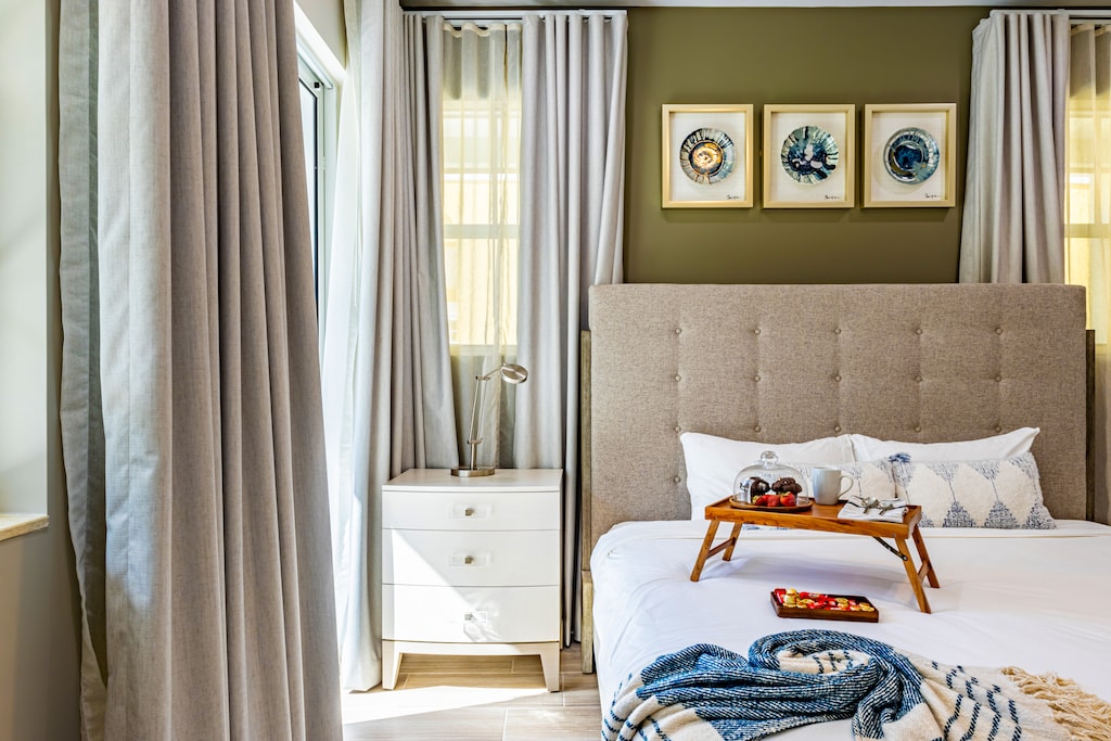 Cozy bedroom with plush bedding, soft natural light, and elegant décor—perfect for a restful night.