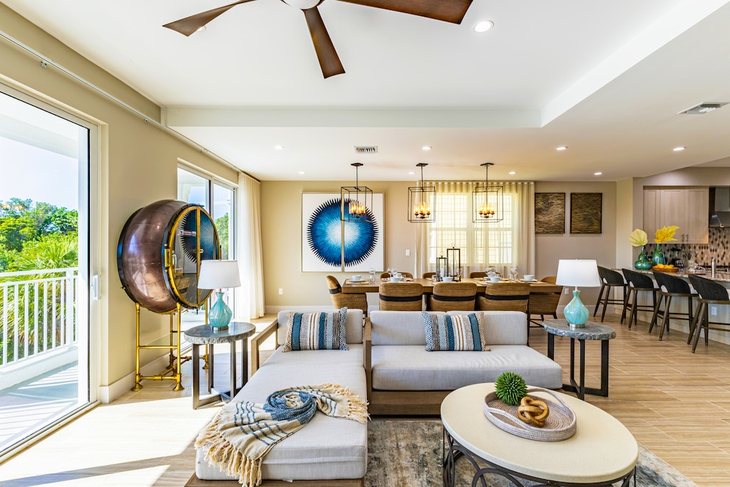 Bright and modern living room with chic décor, cozy seating, and open flow to the dining area.