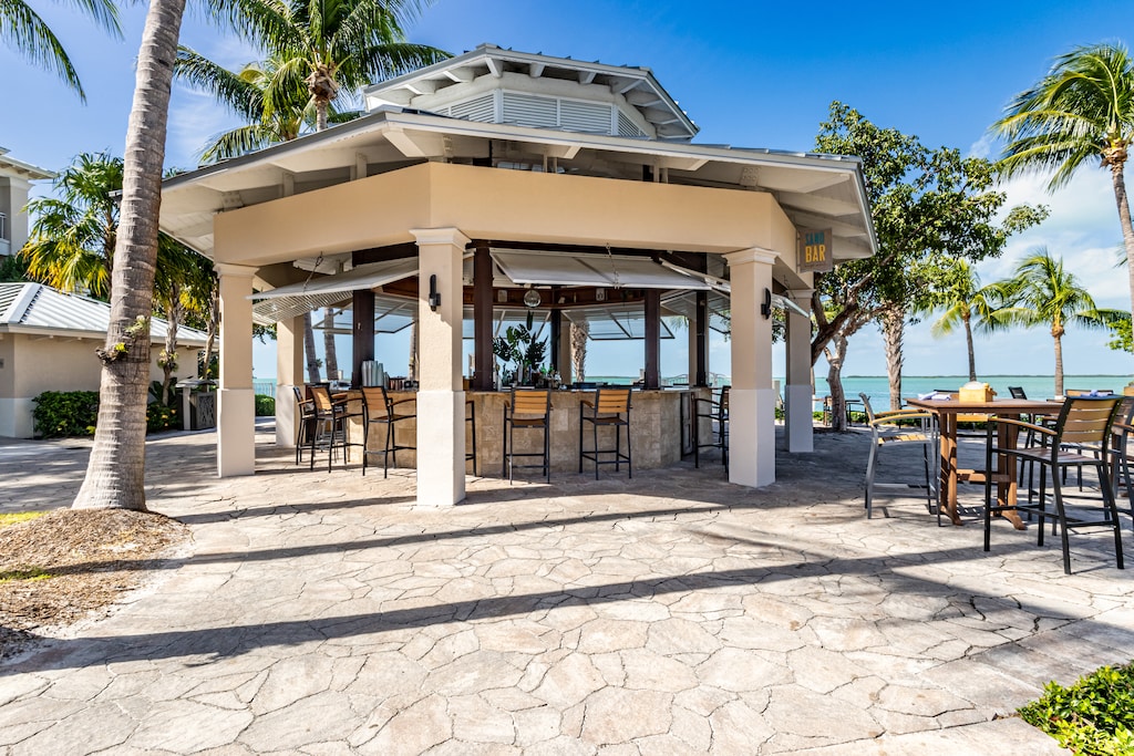 Casual open-air bar steps from the ocean, perfect for tropical drinks.