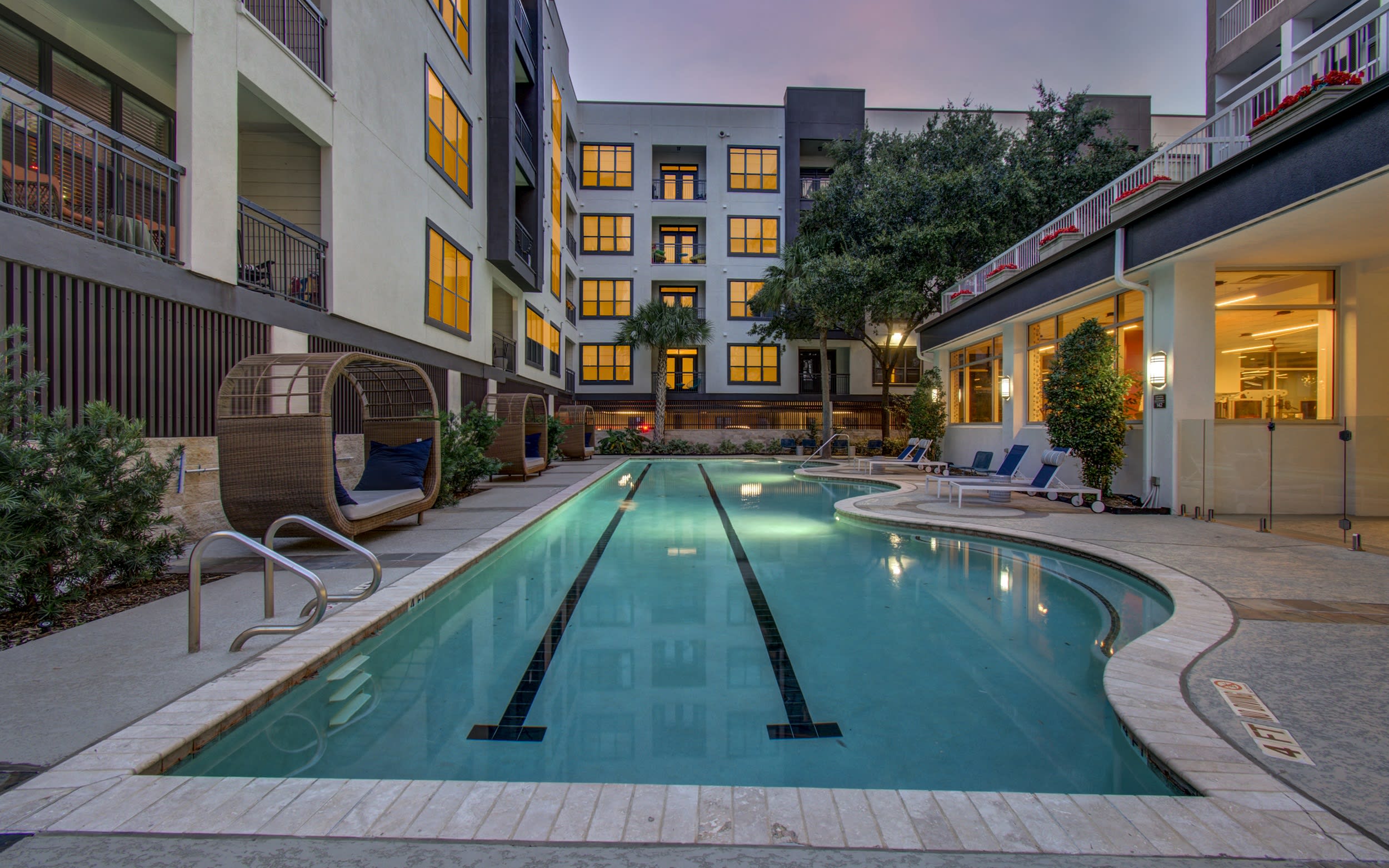 This resort-style pool offers you a tropical oasis to call your own, including poolside loungers and palm trees!