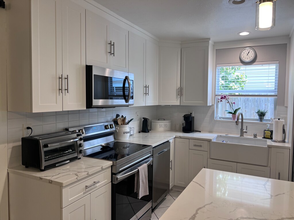 Modern Kitchen  Modern Kitchen with farmers sink, stove, oven, dishwasher, microwave, eat up counter