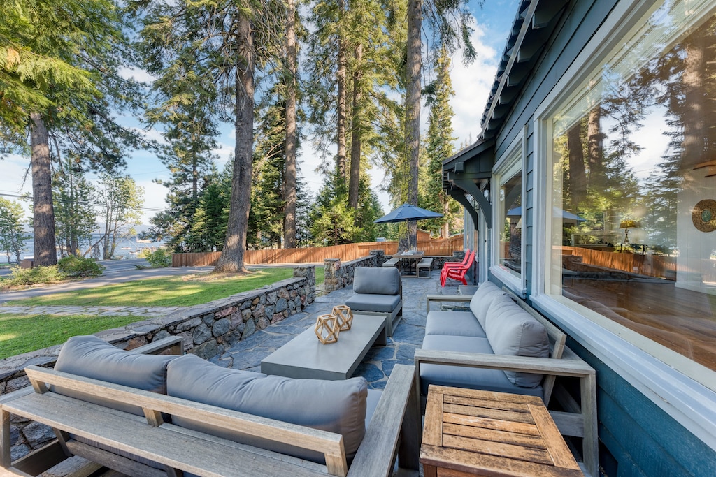 Spacious front patio with outdoor seating and dining areas.