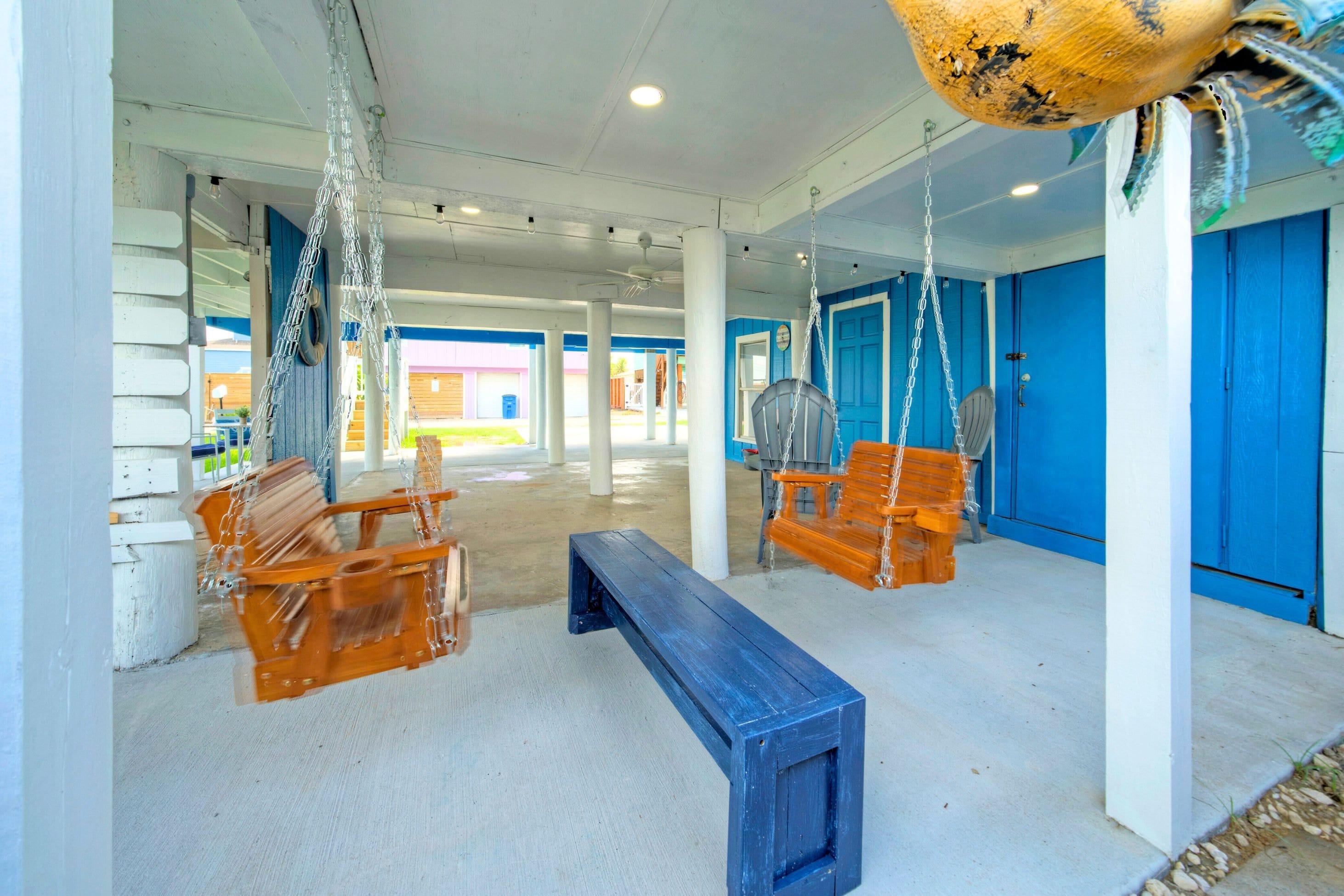 Spacious lower patio with bench swings.