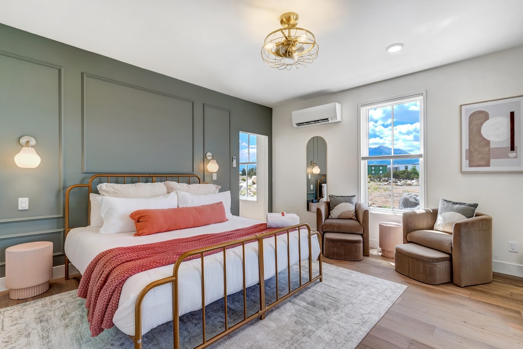 Luxurious master bedroom with a comfortable bed, seating area, and modern amenities.