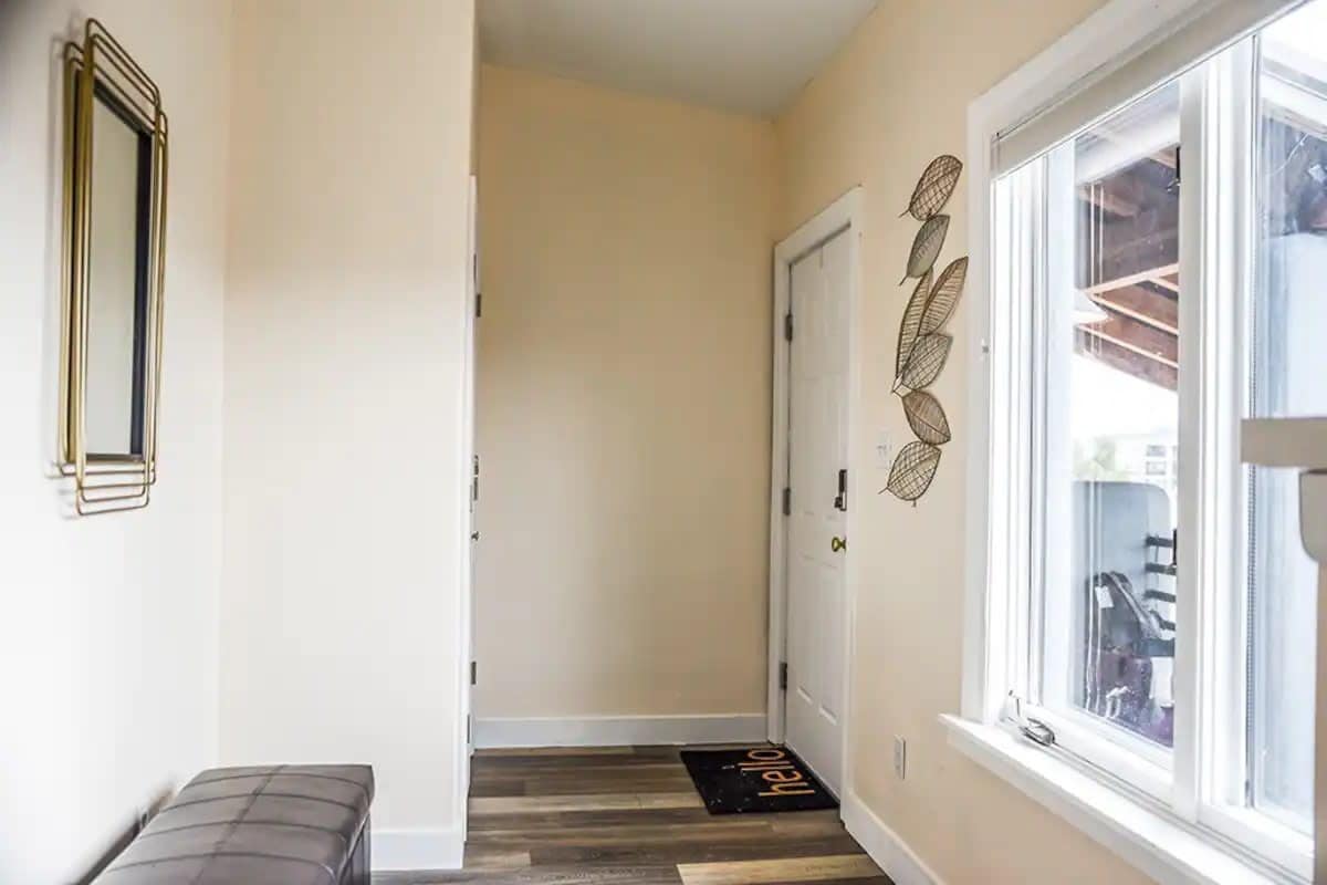 Step into a spacious foyer featuring a comfy bench—a perfect entryway that combines style and comfort. Step into a spacious foyer featuring a comfy bench—a perfect entryway that combines style and comfort.